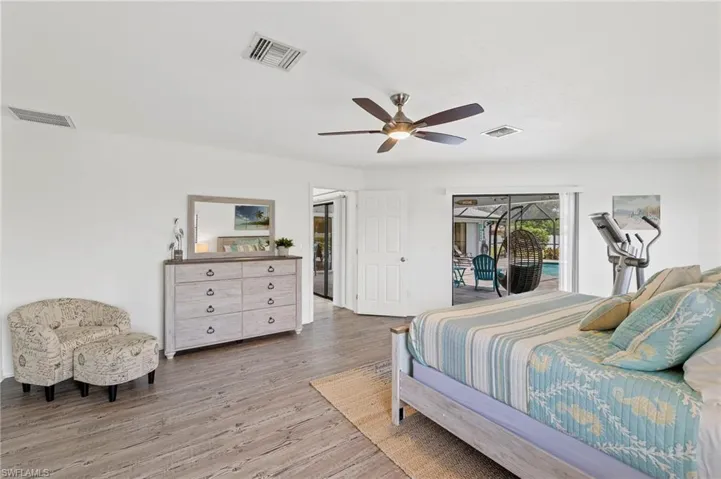 Bedroom with ceiling fan, light hardwood / wood-style flooring, and access to outside