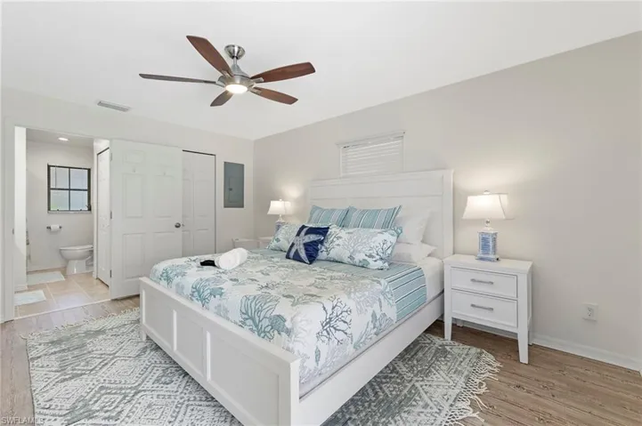 Bedroom with connected bathroom, a closet, ceiling fan, and light hardwood / wood-style flooring