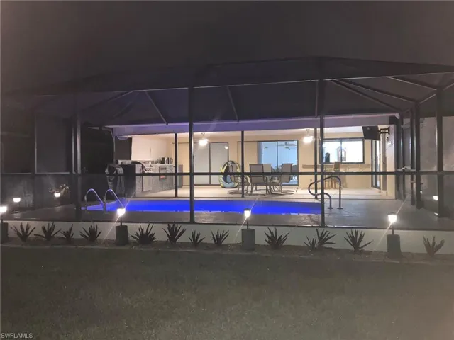 View of swimming pool with a swimming pool, a lanai, and a sunroom