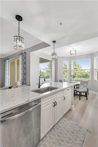 Completely renovated kitchen featuring stainless appliances and beautiful pendant lighting.