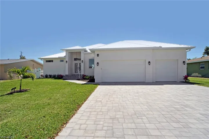 White stucco exterior with a prominent double-door entry