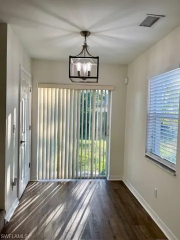 Dinette with natural lighting and a notable chandelier