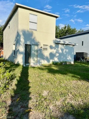 Back of house featuring a yard