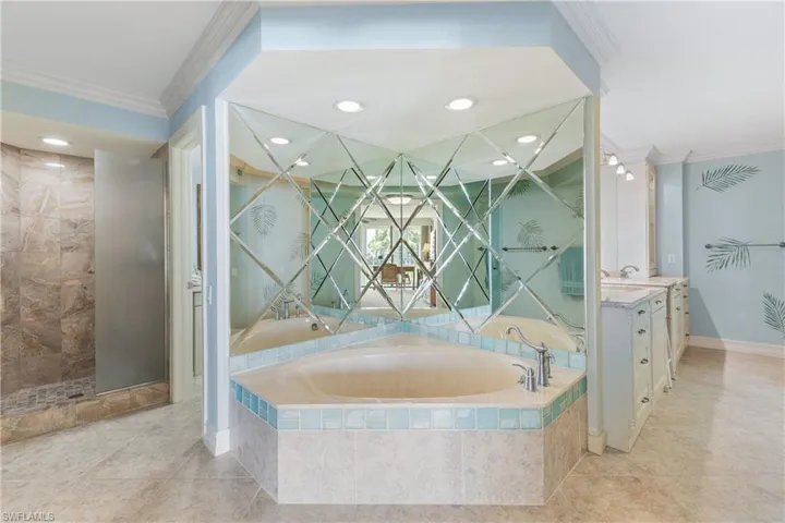 Bathroom with tile flooring, crown molding, and vanity