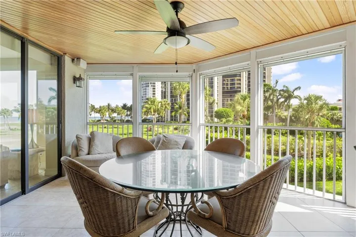 Sunroom featuring ceiling fan and wood ceiling