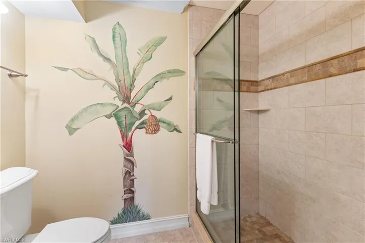 Bathroom featuring an enclosed shower and toilet
