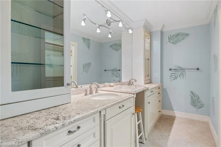 Bathroom with tile flooring, crown molding, a notable chandelier, track lighting, and vanity