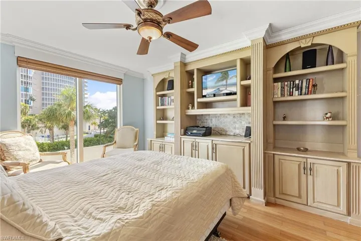 Bedroom featuring light hardwood / wood-style flooring, ceiling fan, access to outside, and crown molding
