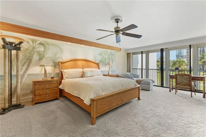 Carpeted bedroom featuring access to outside, ornamental molding, and ceiling fan