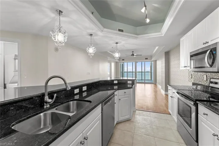 view of river from the kitchen,  double sink, and stunning breakfast bar lights