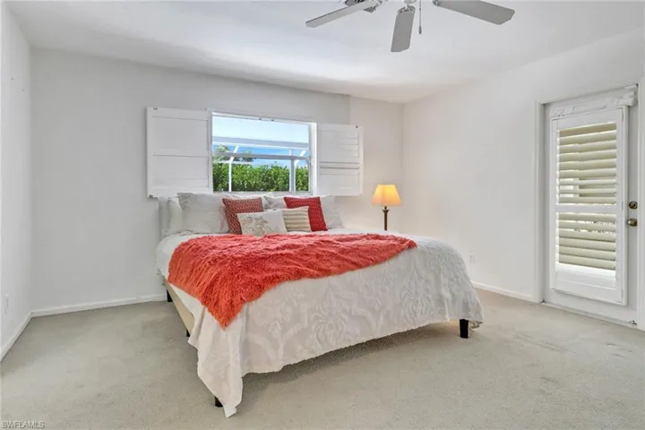 Carpeted bedroom with ceiling fan