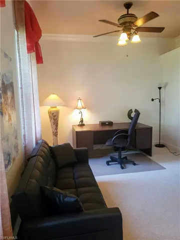 Office with ceiling fan, crown molding, and carpet