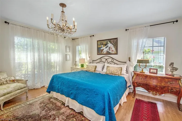 Bedroom featuring light hardwood / wood-style floors and an inviting chandelier