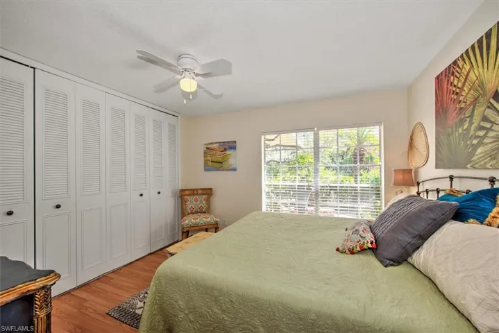 Bedroom featuring ceiling fan, a closet, and hardwood / wood-style floors