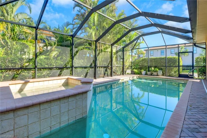 View of swimming pool featuring glass enclosure and sink