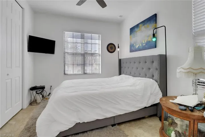 Bedroom with ceiling fan and a closet