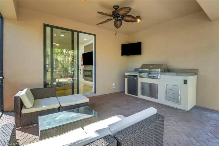 View of patio / terrace with an outdoor living space, a grill, and an outdoor kitchen