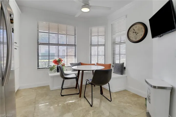 Dining space featuring ceiling fan and crown molding
