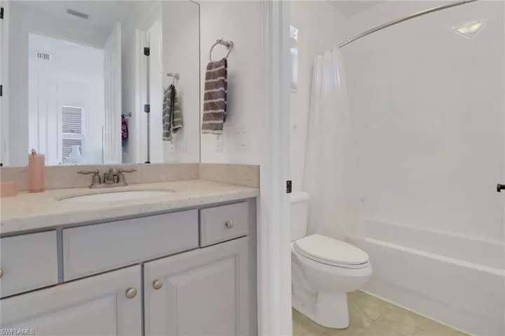 Full bathroom featuring tile patterned floors, vanity, shower / tub combo, and toilet