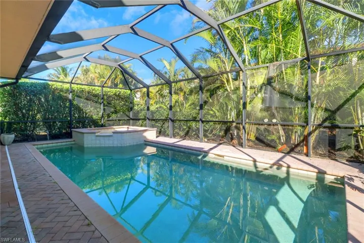 View of swimming pool featuring a lanai