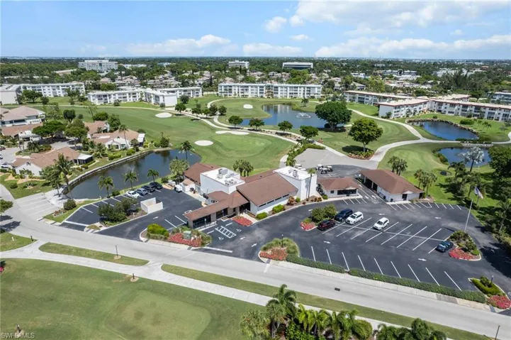 Drone / aerial view of a local golf course and a large body of water