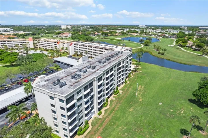 Aerial view of apartment complex / building and a nearby body of water