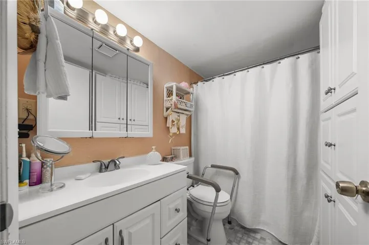 Full bath with vanity and a shower with curtain