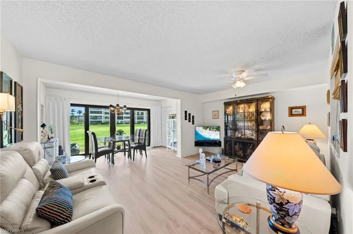 Living room featuring a chandelier, wood finished floors, and a textured ceiling