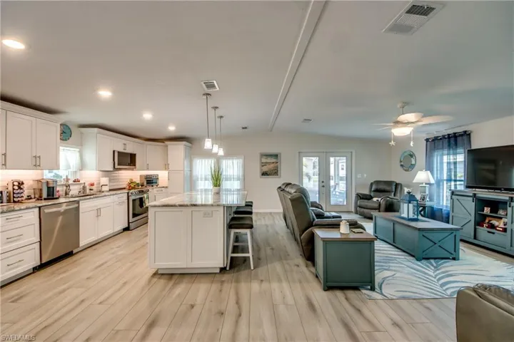 Dining area featuring a chandelier, plenty of natural light, light wood-style flooring, crown molding, and recessed lighting