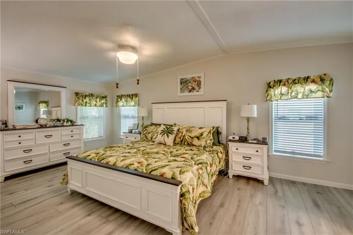Full bath with ornamental molding, double vanity, and wood finished floors