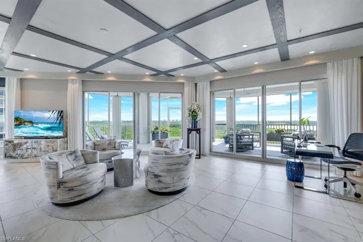 Living room with coffered ceiling and beamed ceiling