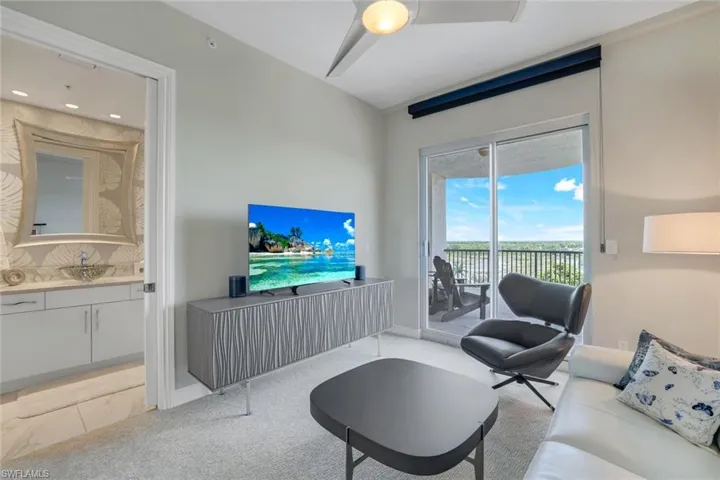 Living room featuring sink, ceiling fan, and light colored carpet