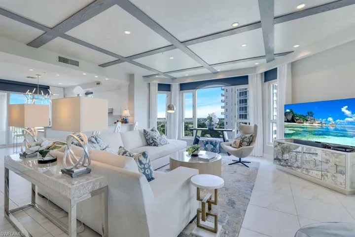 Living room featuring coffered ceiling and beamed ceiling