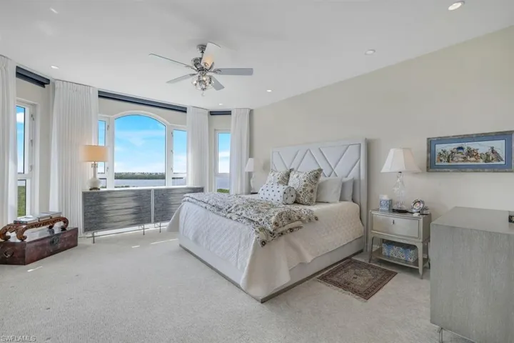 Carpeted bedroom with ceiling fan
