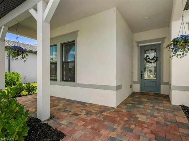 View of exterior entry with stucco siding