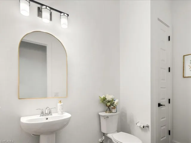 Half bathroom featuring toilet and a sink