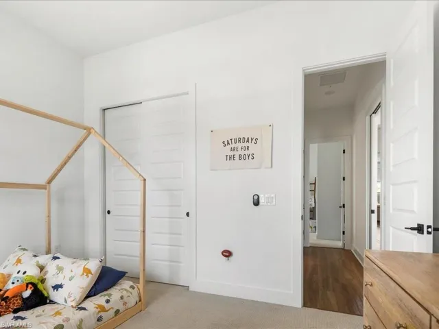 Bedroom with carpet floors, a closet, and baseboards