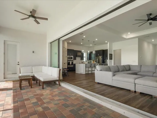 Living area with brick floor, recessed lighting, and ceiling fan