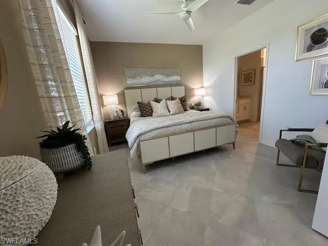 Bedroom with a ceiling fan and ensuite bathroom