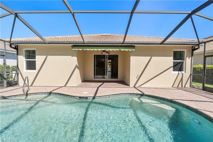 Pool featuring enclosure and a patio