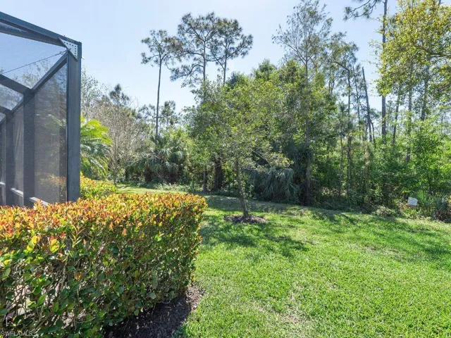 View of yard with a lanai