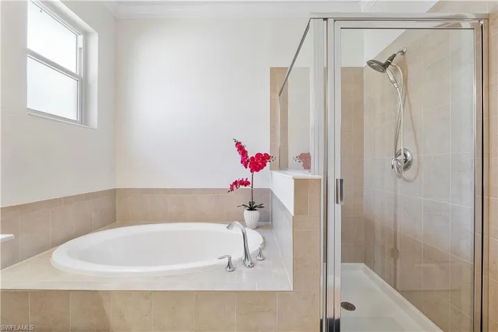 Full bathroom with a garden tub and a shower stall