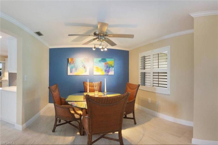 Dining room with crown molding, plantation shutters and custom fan with lights to highlight your artwork