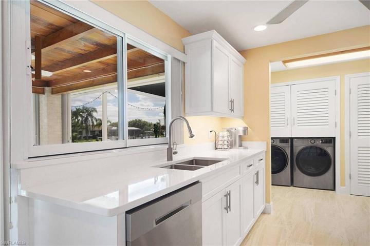 Samsung washer and dryer 2023. Samsung dishwasher 2023. additional closet and storage shelving in laundry area