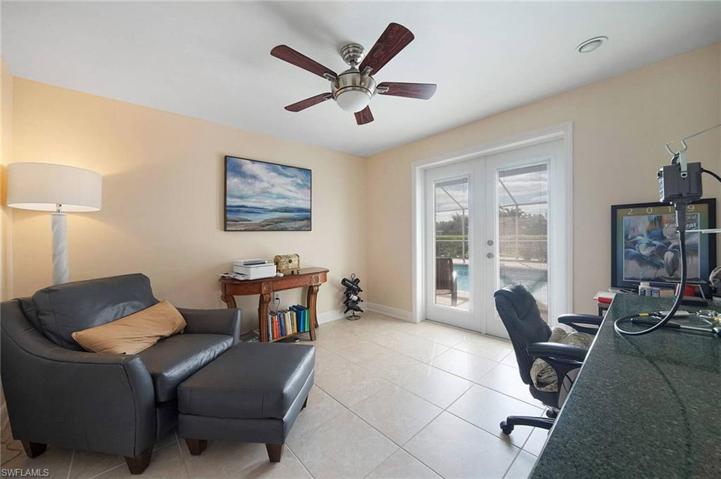 Large den with french doors to pool off the master bedroom. hurricane impact french doors.