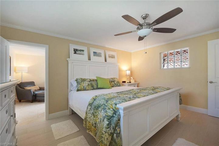 Master Bedroom with crown molding, tile floors has its own den/flex room behind. use as nursery, office, crafts etc...