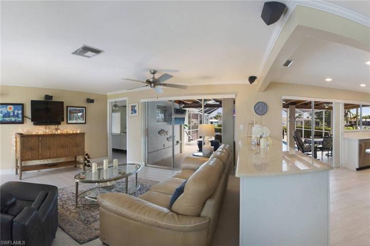 Wide open contemporary design capturing the view of pool and canal as soon as you step inside..