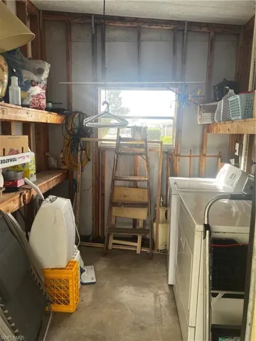 Laundry room featuring concrete flooring