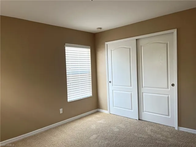 Unfurnished bedroom with carpet flooring and a closet