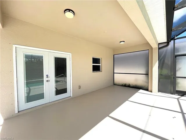 View of patio with french doors and a lanai